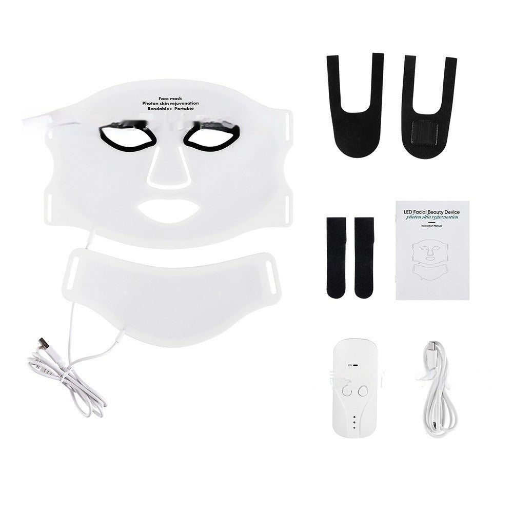 The LumiLift™ Red Light Therapy Silicone Face Mask set includes a white LED face mask with a connected lower mask, black head straps, remote control, USB charging cable, user manual, and two small black pads arranged neatly on a white background.