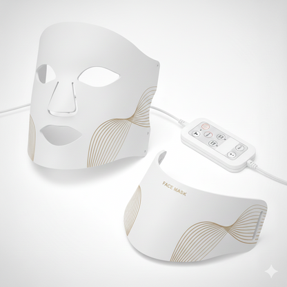 The LumiLift™ Red Light Therapy Silicone Face Mask is a white LED mask with gold wave patterns, eye/nose/mouth cutouts, a matching chin piece labeled FACE MASK, and a white wired remote for easy control.